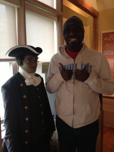 another student posing with Benjamin Banneker's statue